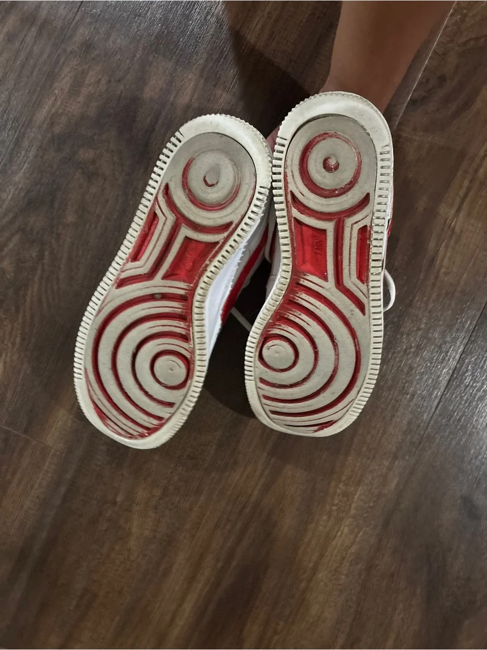 Nike Air Force 1 white sneakers with red Nike swoosh